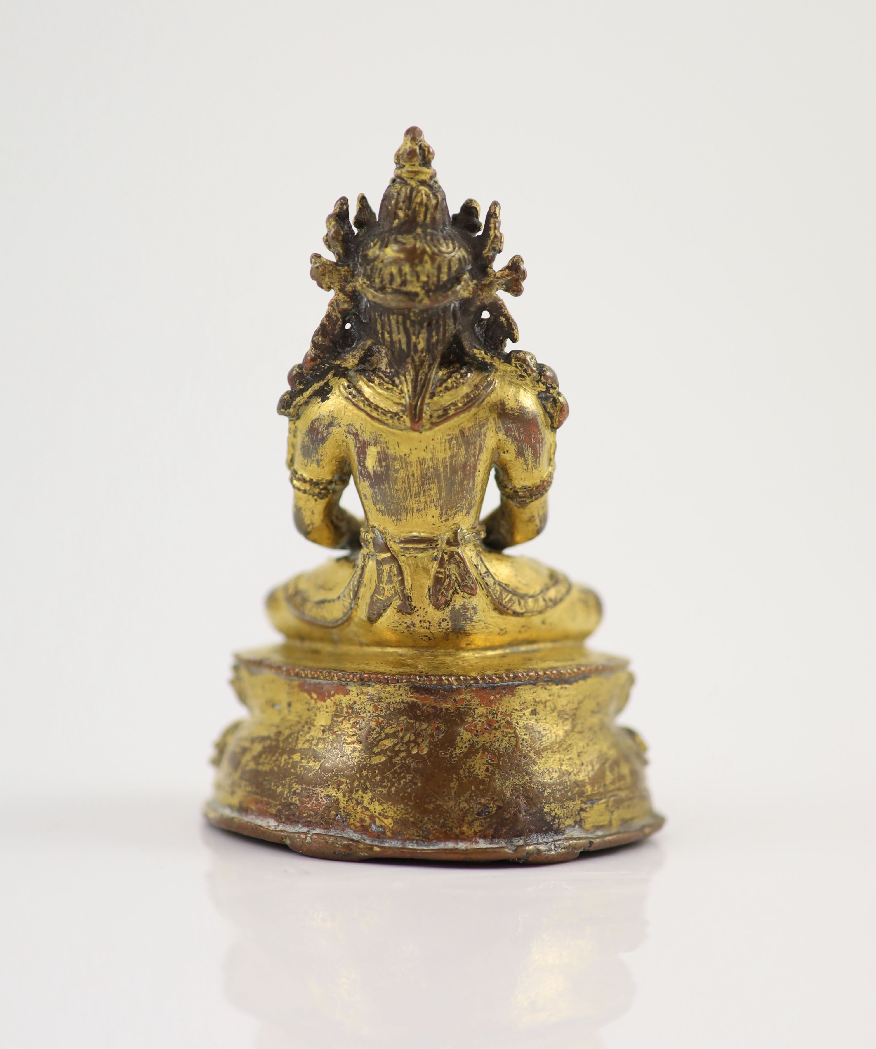 A Tibetan gilt copper alloy seated figure of Amitayus, possibly 15th/16th century, 9cm high